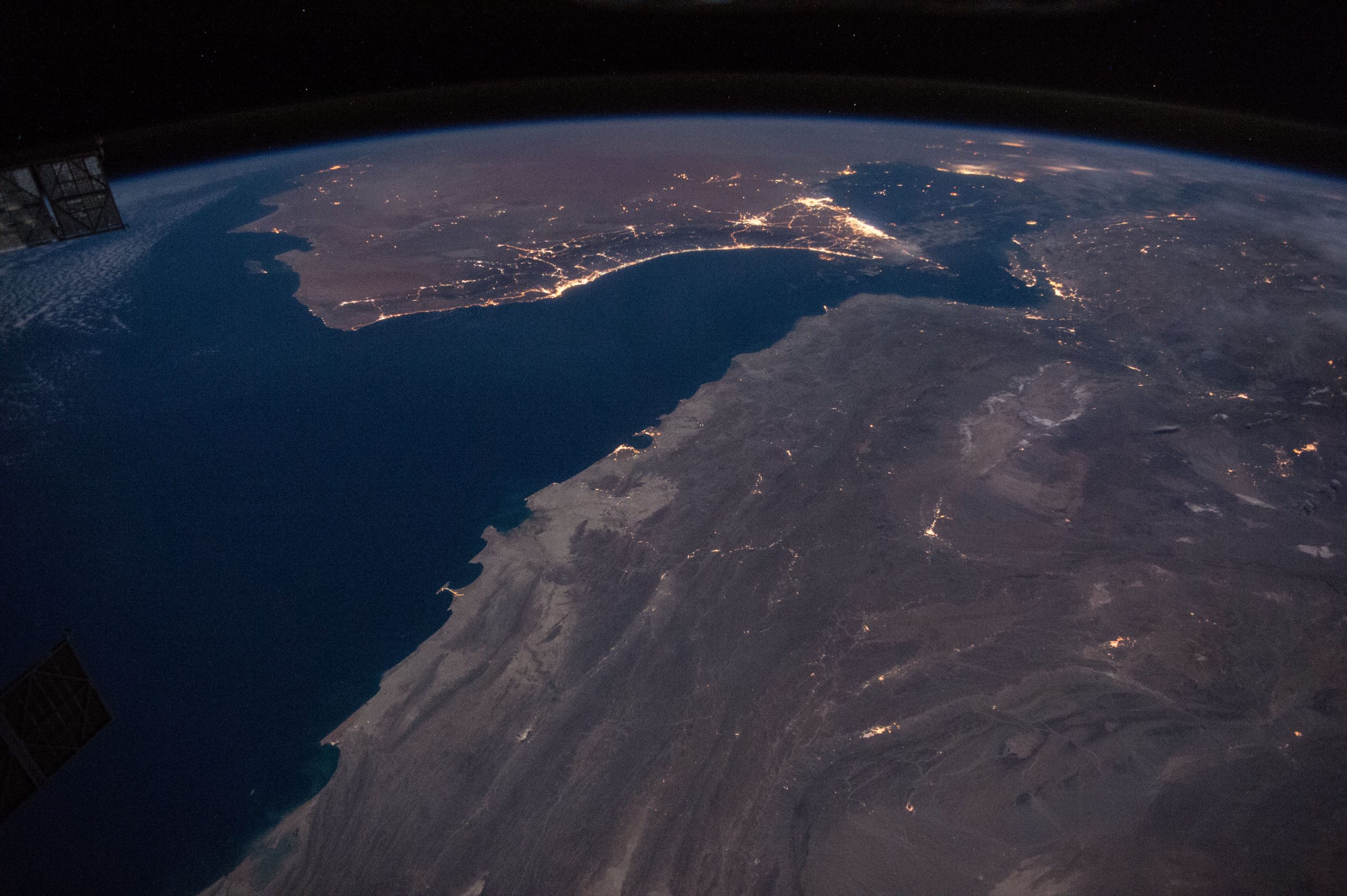 The Strait of Hormuz with Gulf of Oman, showing Iran lower-right and Gulf States top-centre (Photograph: NASA/Tim Kopra, <a href='https://commons.wikimedia.org/wiki/File:ISS-46_Gulf_of_Oman_with_Strait_of_Hormuz_at_night.jpg' target='_blank'>Wikimedia Commons</a>)